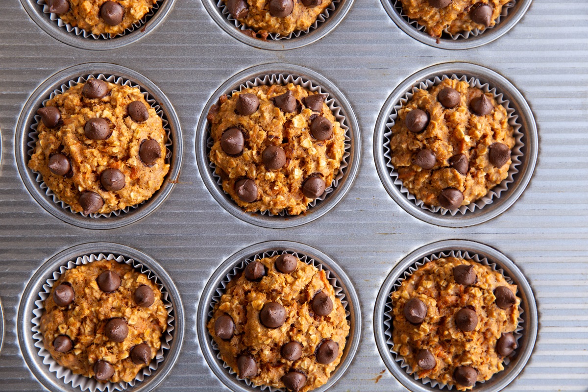 Sweet potato oatmeal muffin cups in a muffin tin, fresh out of the oven.