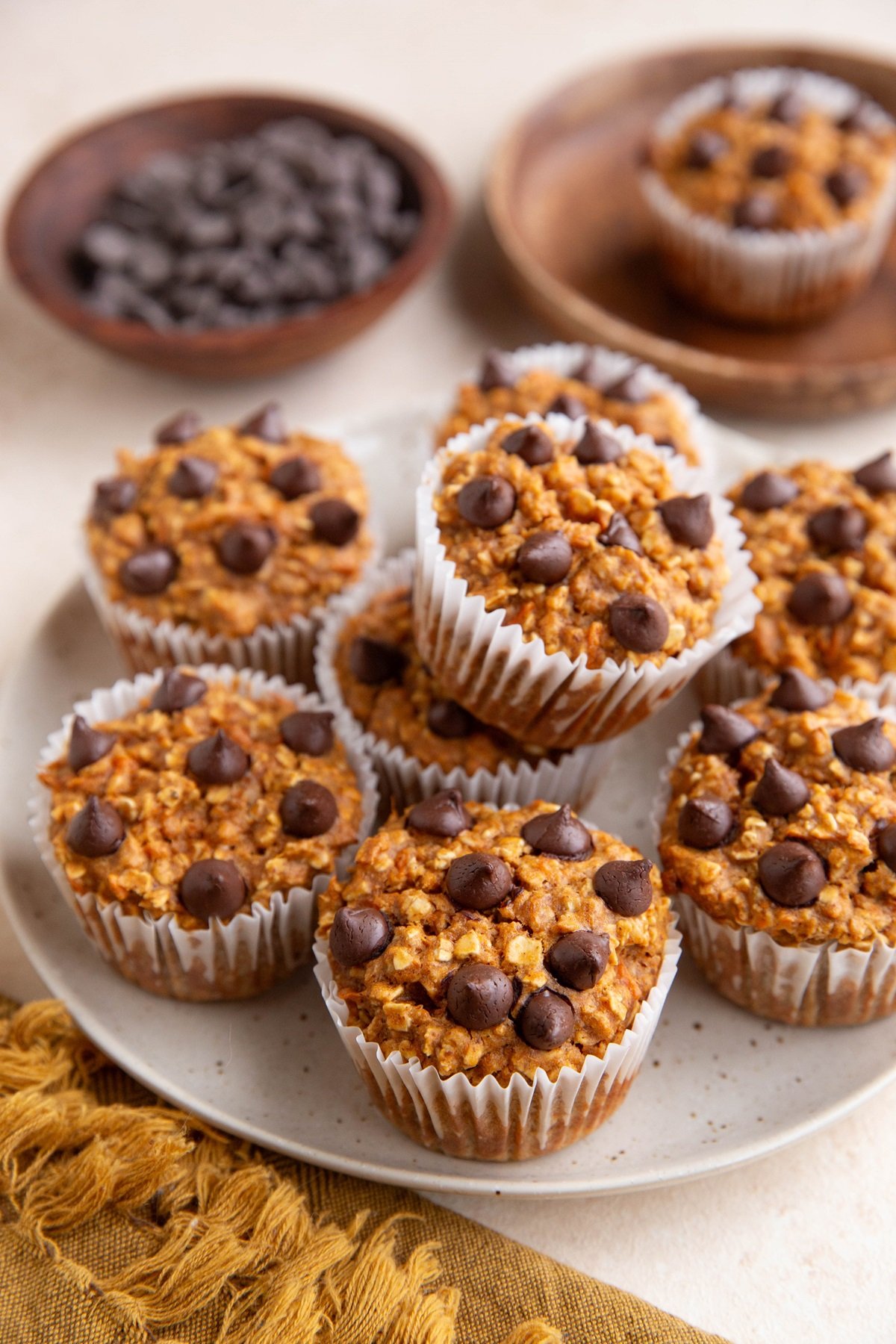 Plate of sweet potato oatmeal muffins with chocolate chips on top, ready to eat.