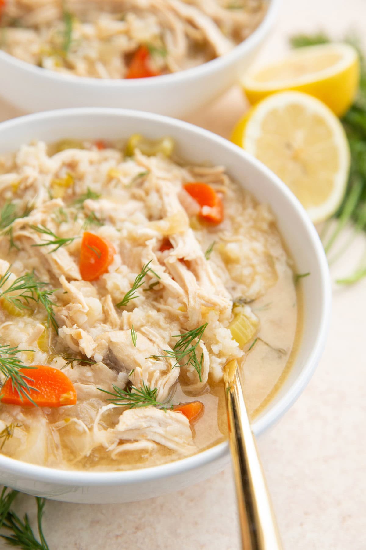 Two white bowls of Greek soup.