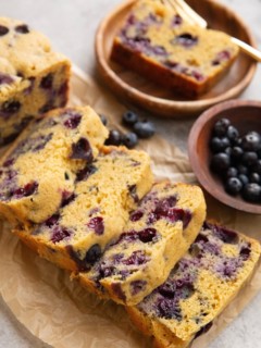 Loaf of blueberry bread cut into slices.