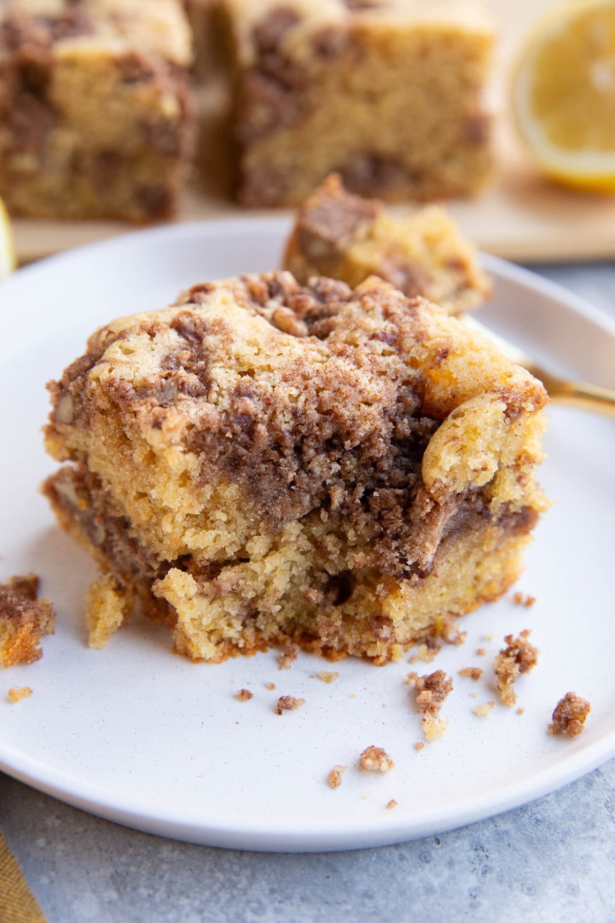 Hunk of coffee cake on a white plate.