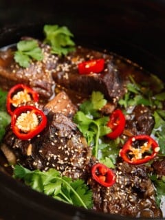 slow cooker full of Asian braised beef short ribs.