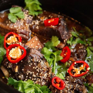 slow cooker full of Asian braised beef short ribs.