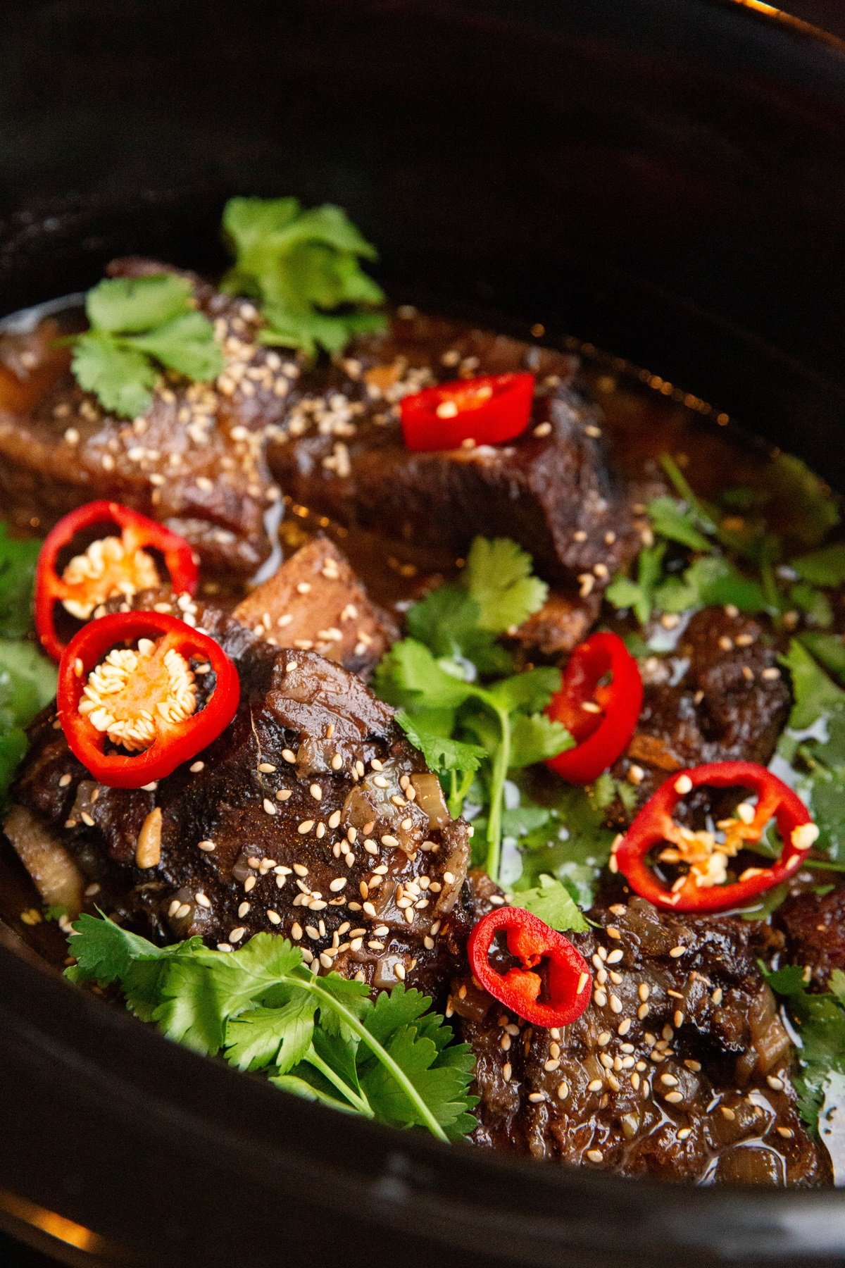 slow cooker full of Asian braised beef short ribs.