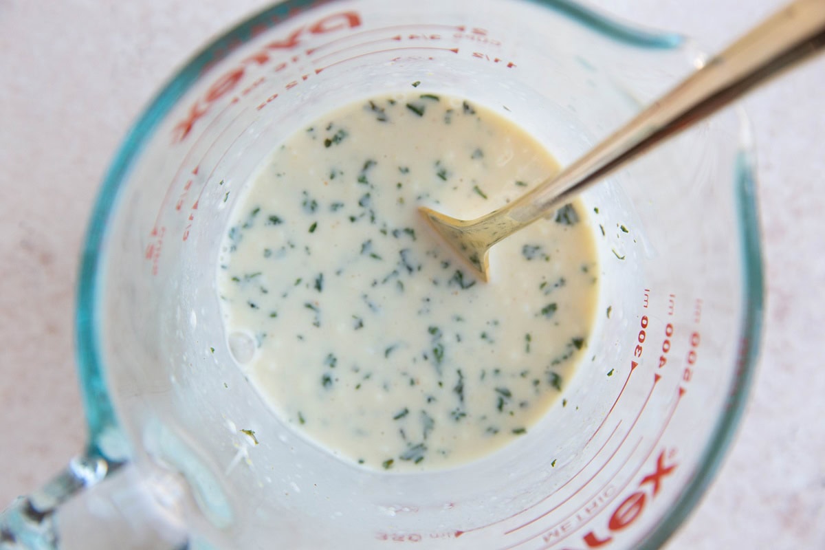 Coleslaw dressing mixed up in a measuring cup.