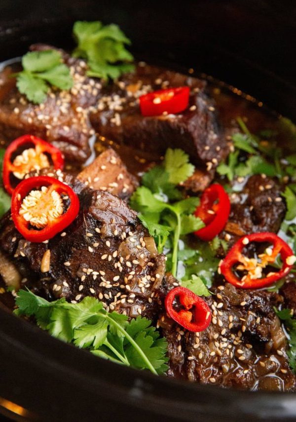 slow cooker full of Asian braised beef short ribs.