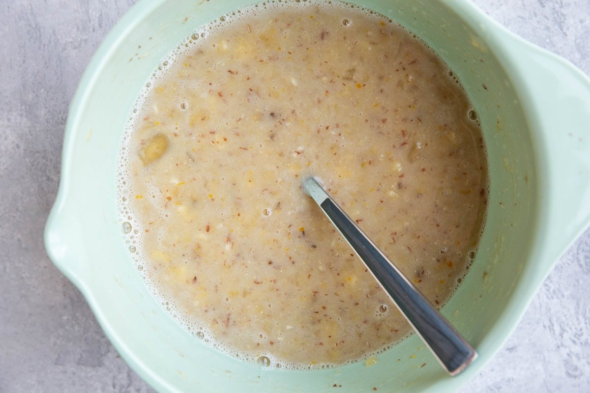 mashed banana, pure maple syrup, eggs, etc in a mixing bowl.