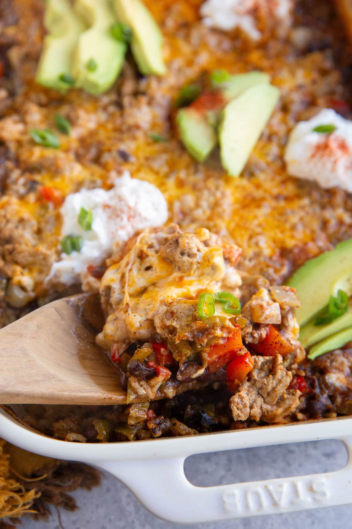 Casserole dish of ground turkey, rice, cheese, beans and more, ready to serve.