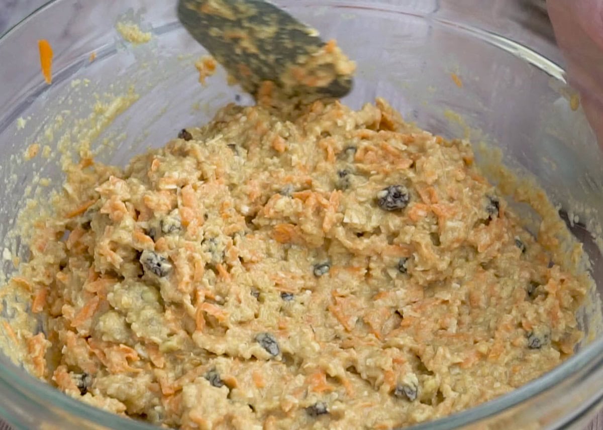 Carrot cake batter in a mixing bowl, ready to be baked.