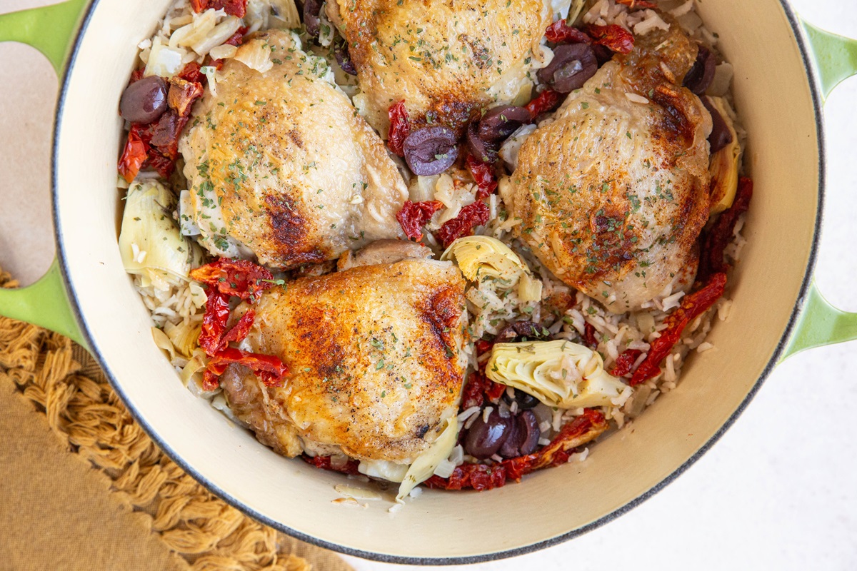 Mediterranean chicken and rice in a Dutch oven, ready to serve.