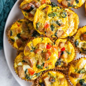 Sausage egg muffins on a white plate, ready to serve.