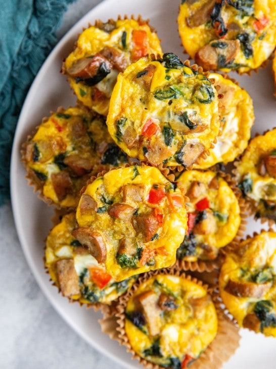 Sausage egg muffins on a white plate, ready to serve.