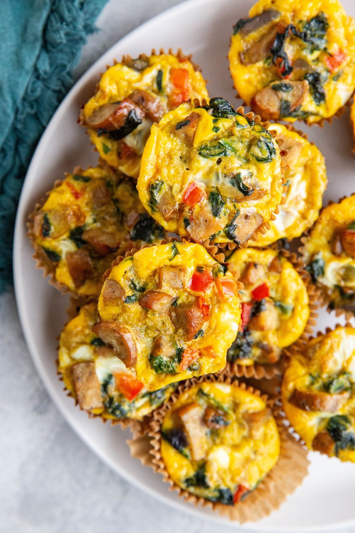 Sausage egg muffins on a white plate, ready to serve.