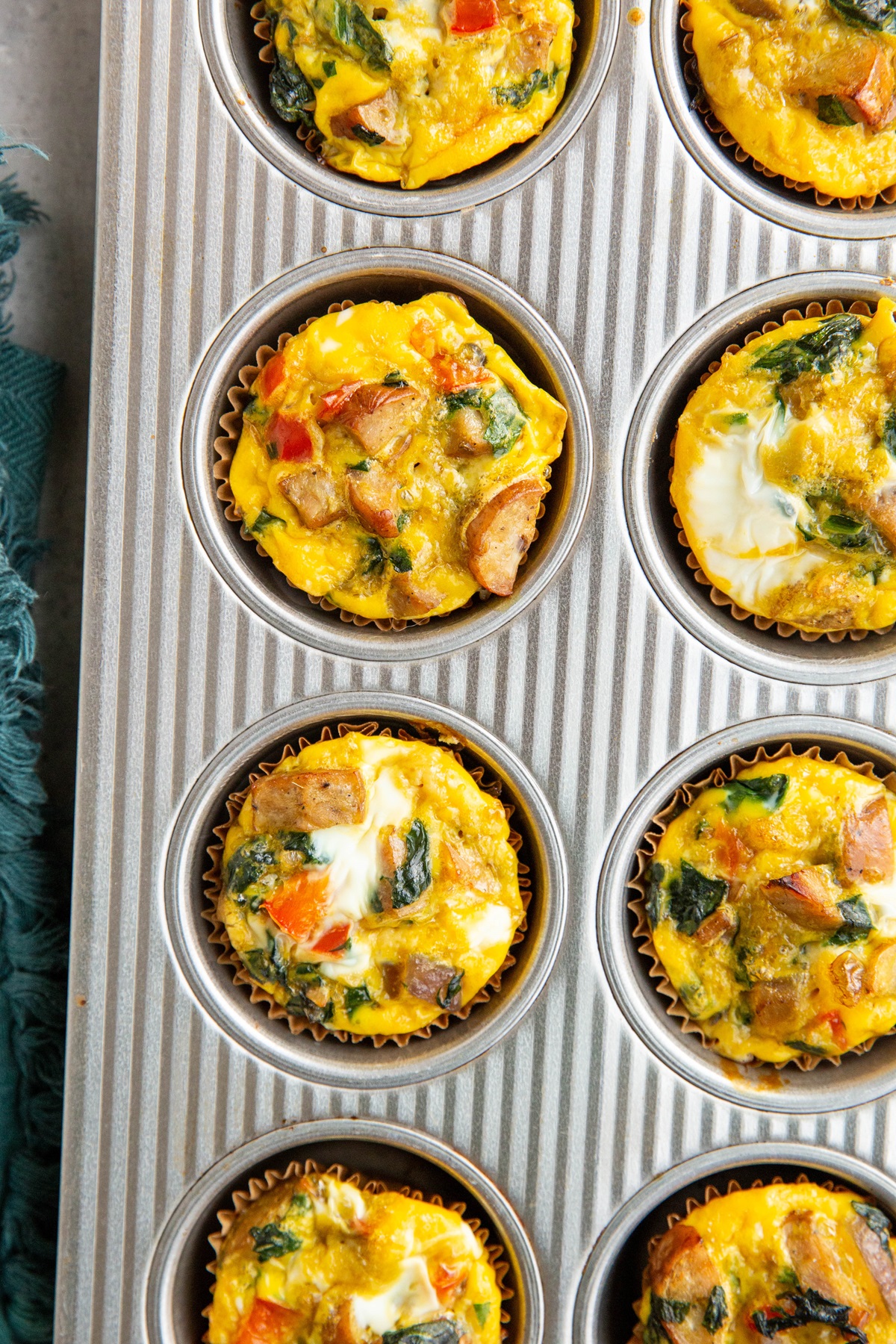 Muffin pan full of sausage egg muffins.