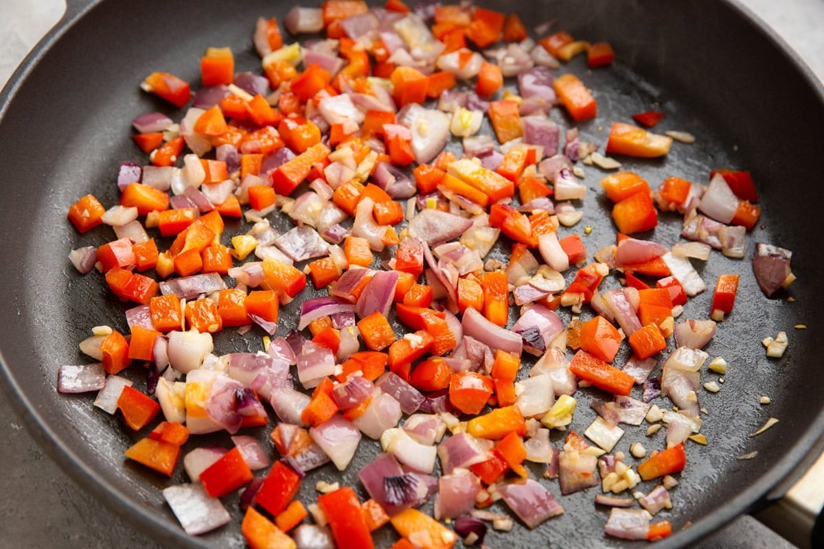 Skillet with onion, bell pepper, and garlic.