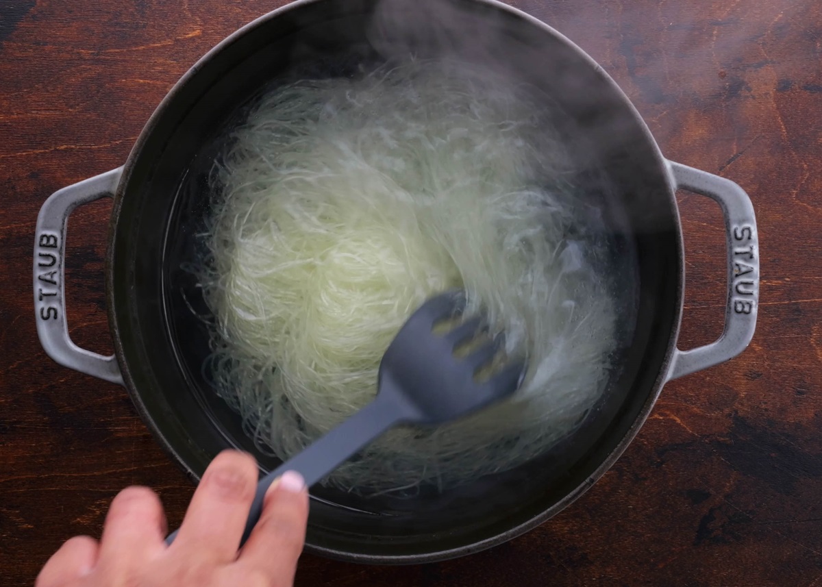 Cooking vermicilli rice noodles in a large pot of water.