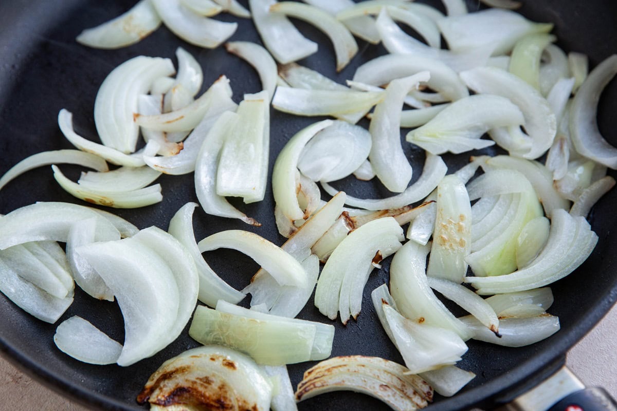 Onions cooking in a skillet.