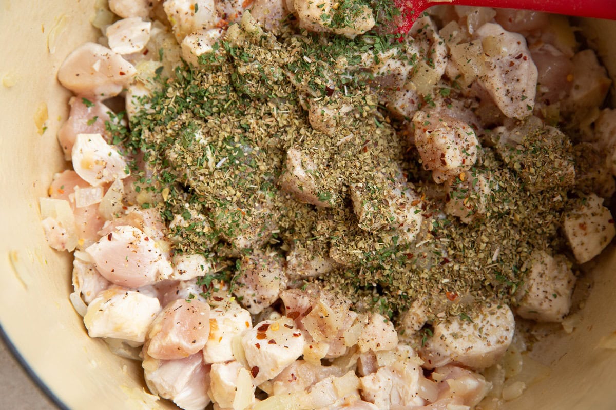 Seasonings added on top of the chicken.