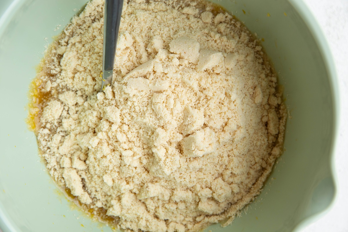 Mixing bowl with wet ingredients and dry ingredients on top, ready to be mixed together.