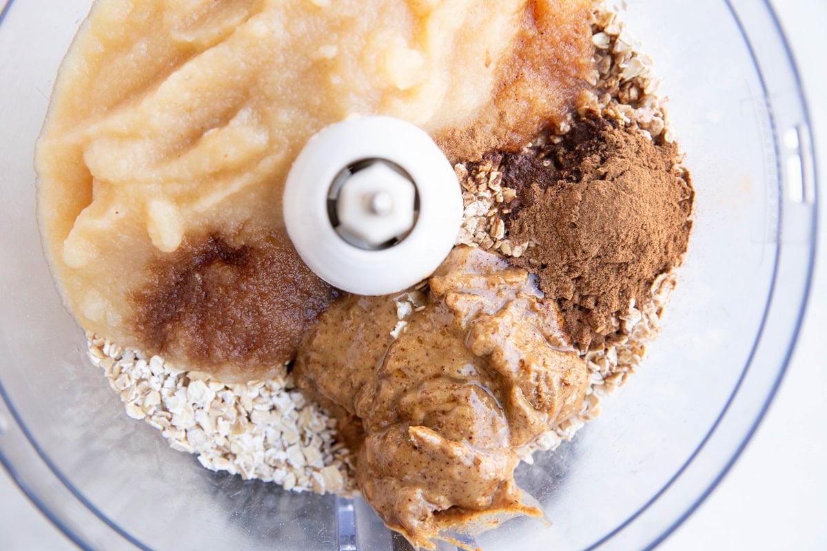 Ingredients for oatmeal applesauce cookies in a food processor, ready to be blended together.