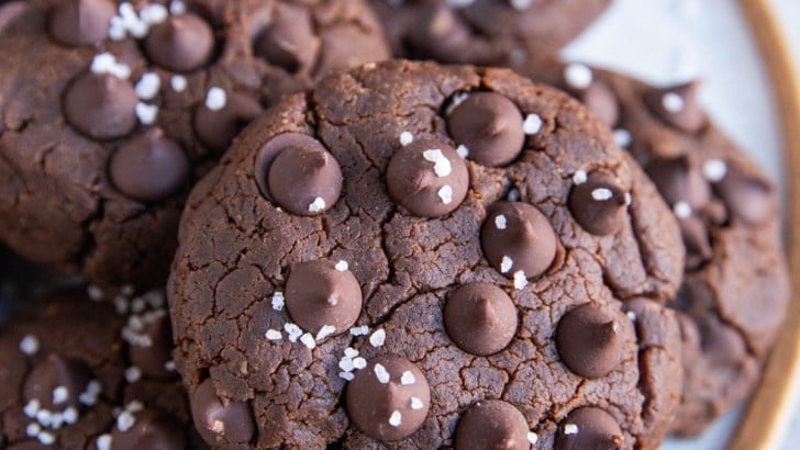 Plate with chocolate chickpea cookies on top, close up and sprinkled with coarse sea salt.