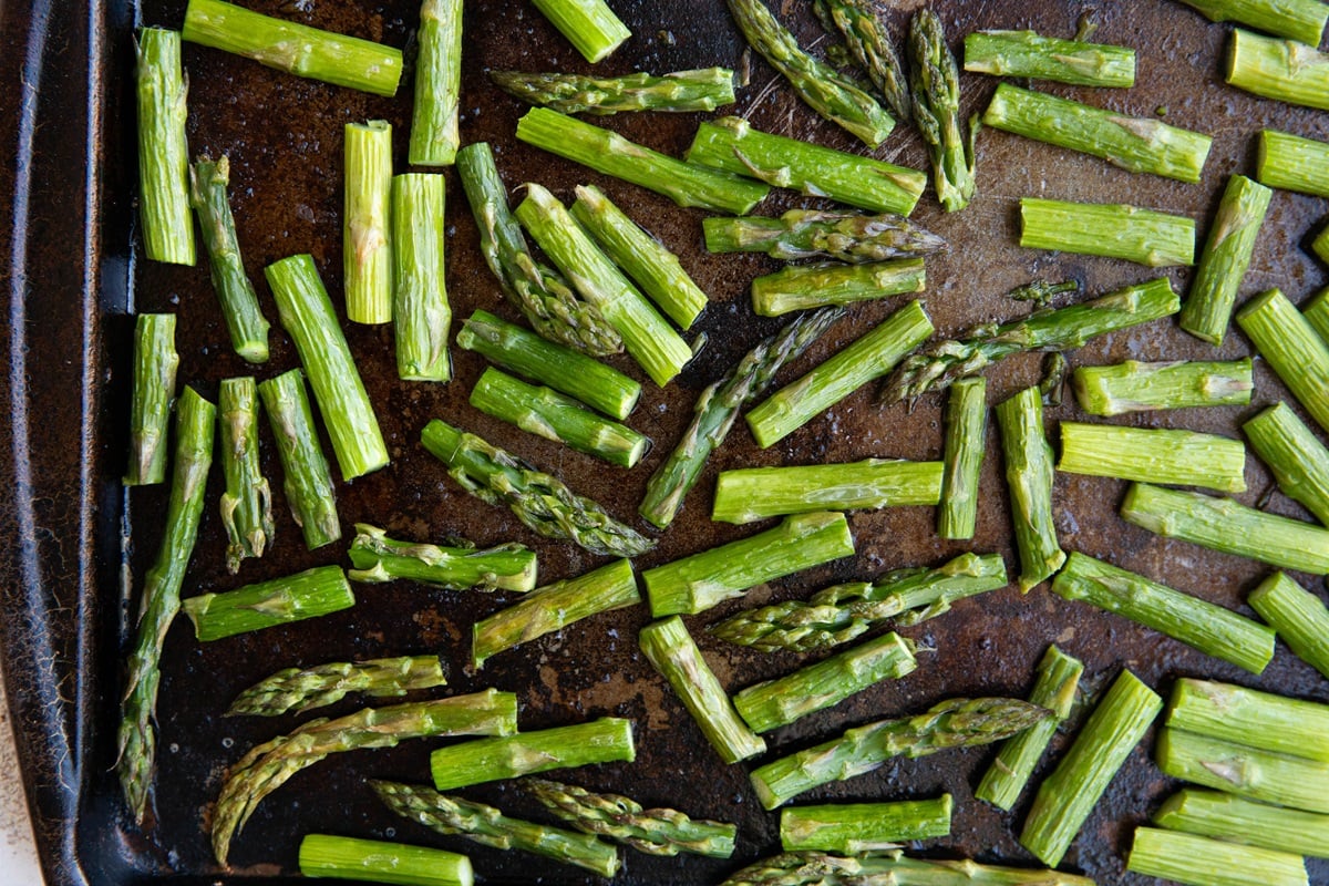 Roasted asparagus on a baking sheet.