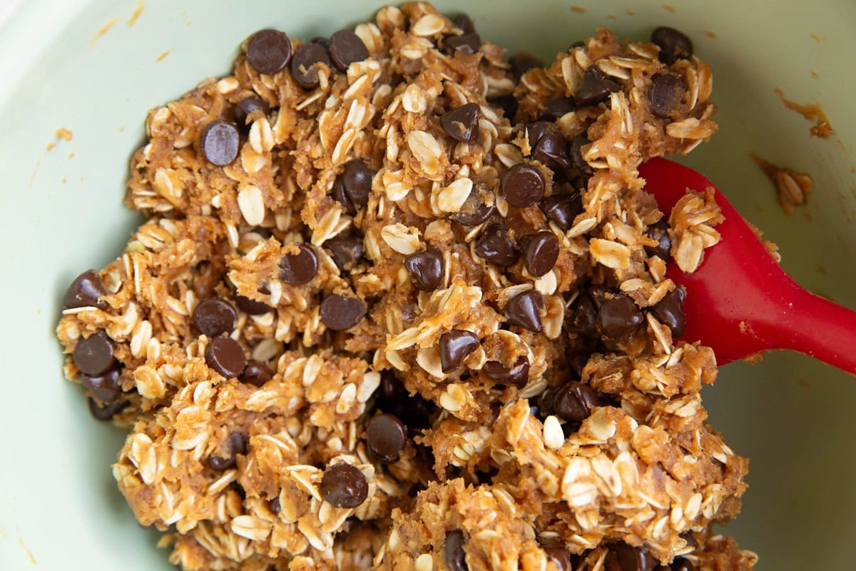 Mixing bowl full of peanut butter oatmeal chocolate chip cookie dough, ready to be baked.