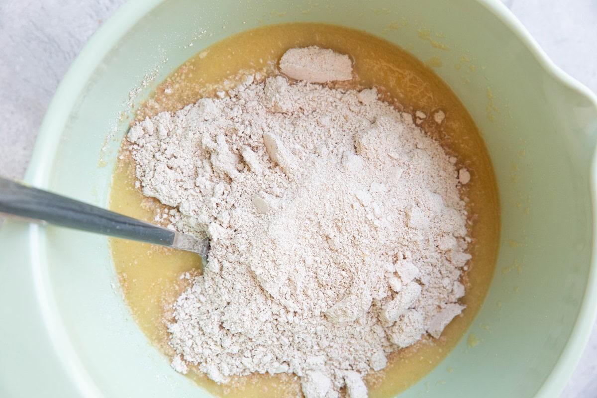 Dry ingredients on top of wet ingredients in a mixing bowl.