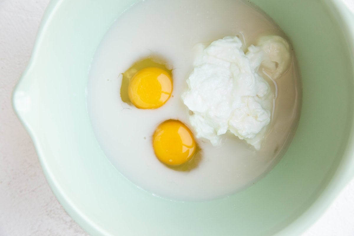 Wet ingredients for protein muffins in a mixing bowl.