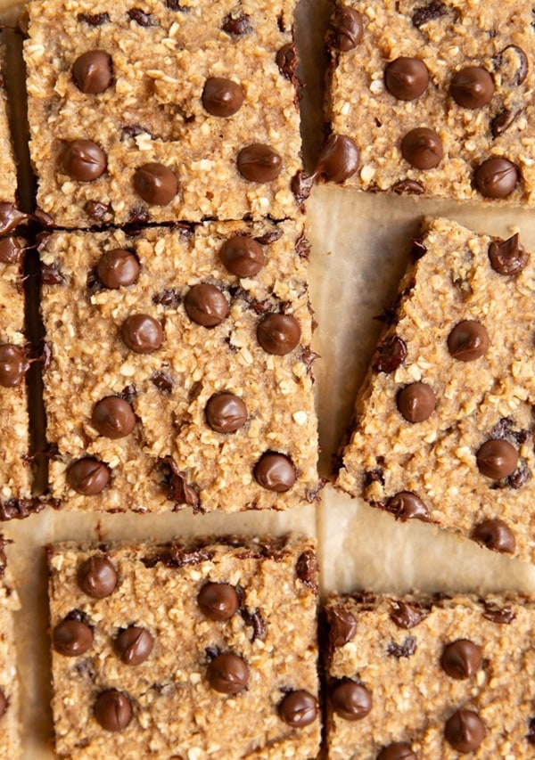 Chocolate chip applesauce bars cut into slices on a sheet of parchment paper.