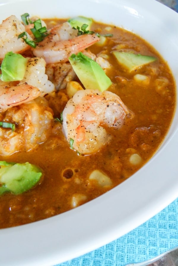 Smokey corn chowder with shrimp and avocado on top.