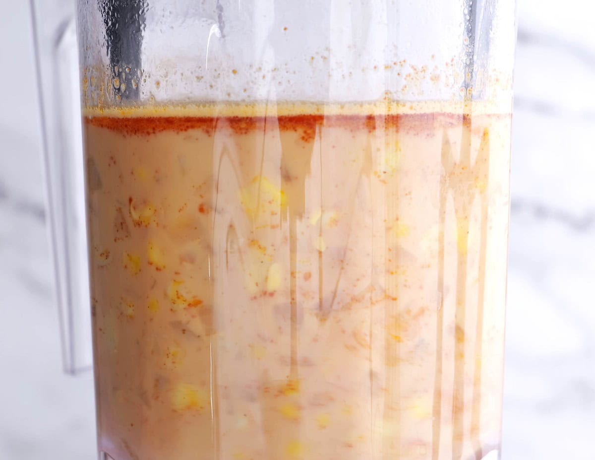 Blender with soup inside to be blended.