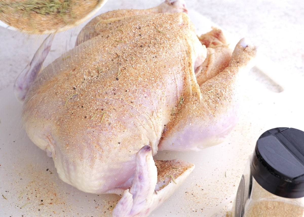 Sprinkling chicken with seasonings
