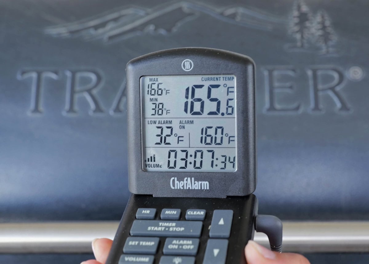 Hand holding temperature gauge