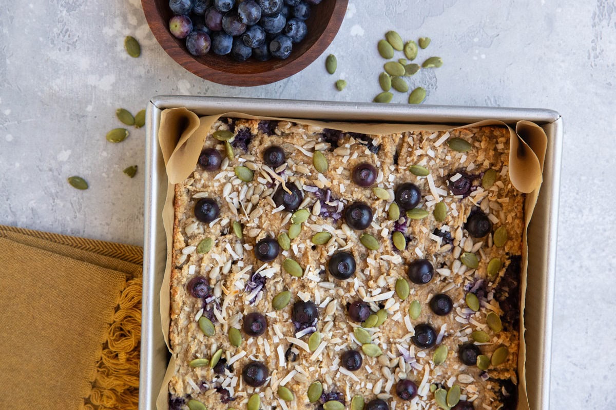 Baking dish of blueberry banana almond flour breakfast bars in a baking dish.