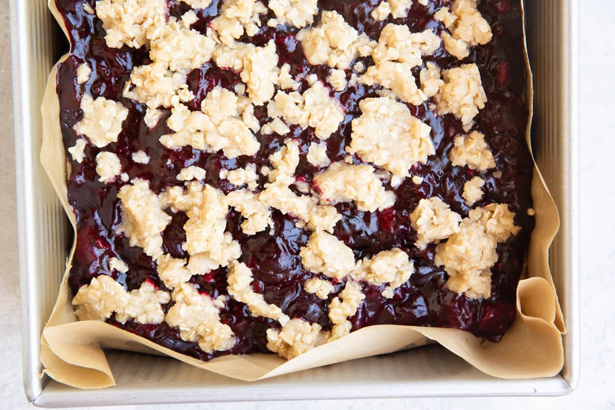 Baking dish with cherry pie ingredients inside, ready to go into the oven.