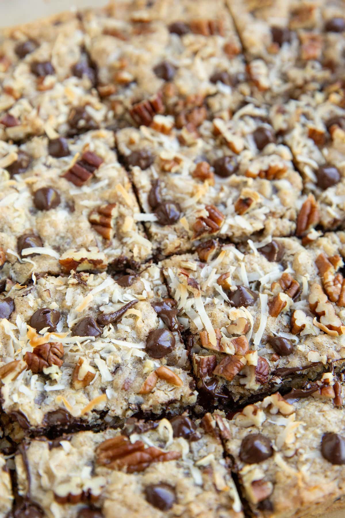Cookie bars cut into squares on a sheet of parchment paper, ready to serve.