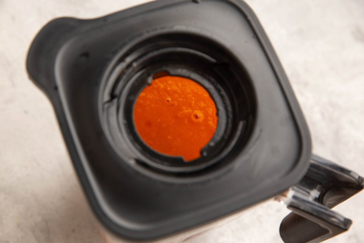 Blender with a top on with the center insert removed to allow steam to escape.
