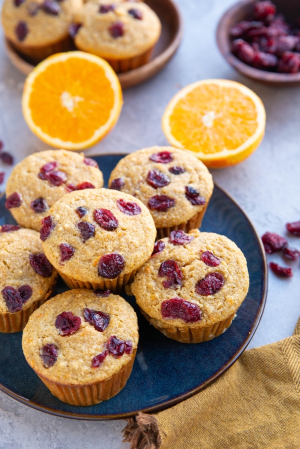 Blue plate of cranberry orange muffins.
