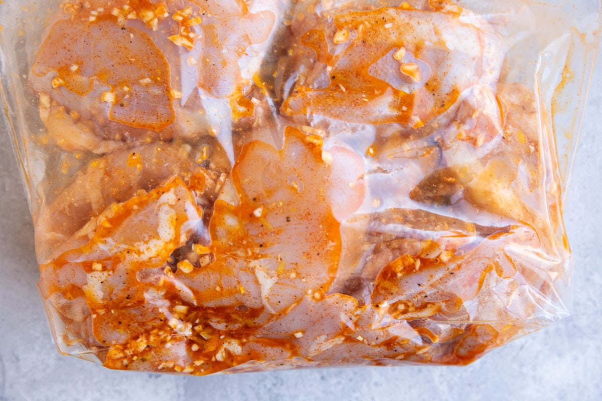 Large zip lock bag full of marinated chicken.