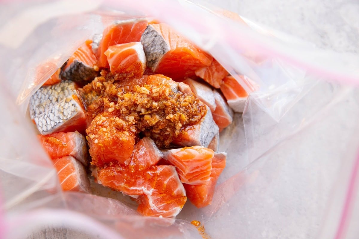Salmon bites in a zip lock bag with marinade poured in.