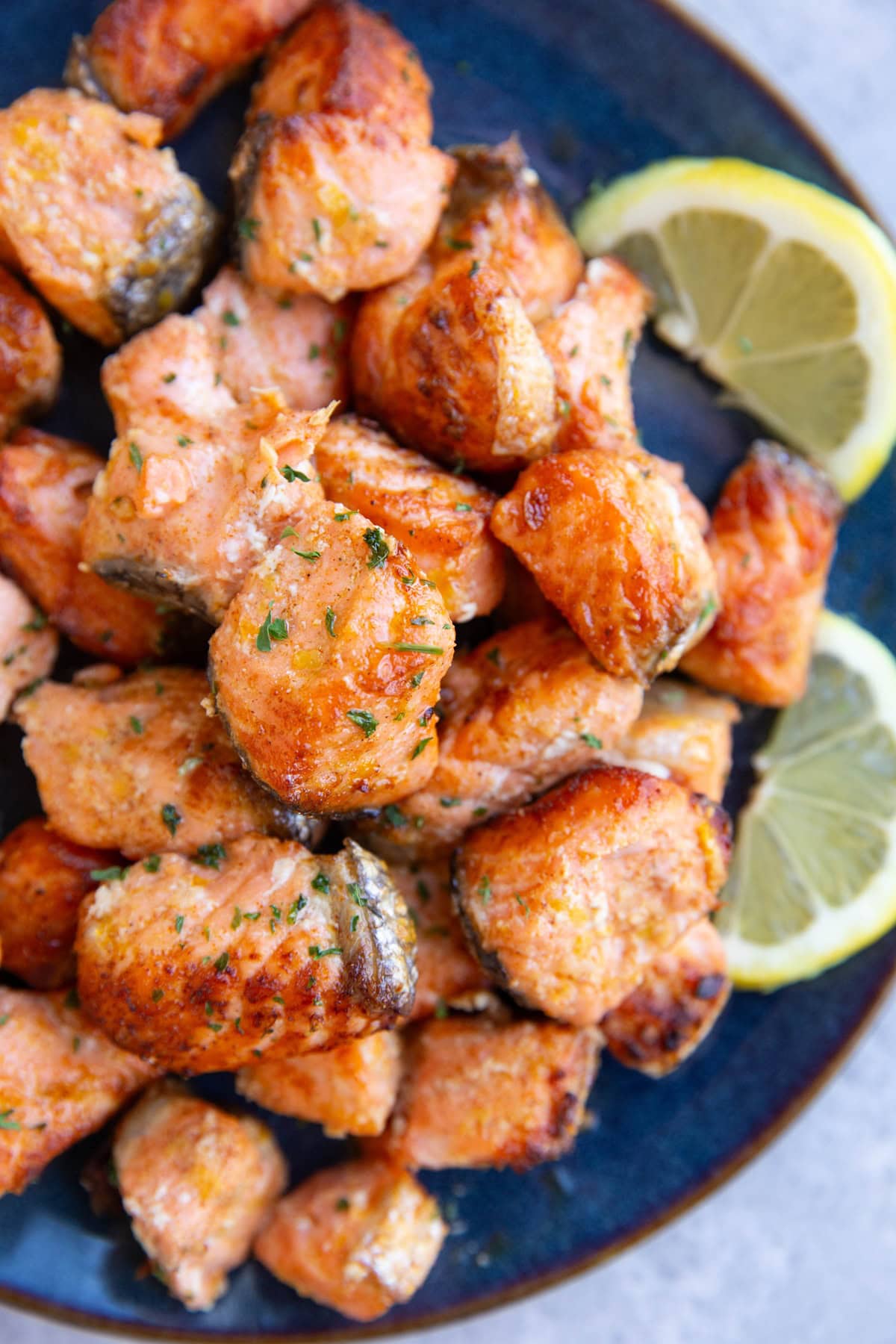 Blue plate full of lemon garlic salmon bites.