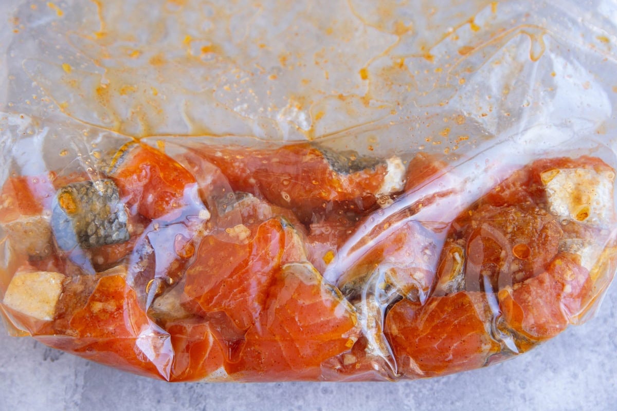 Zip lock bag full of salmon bites being marinated.