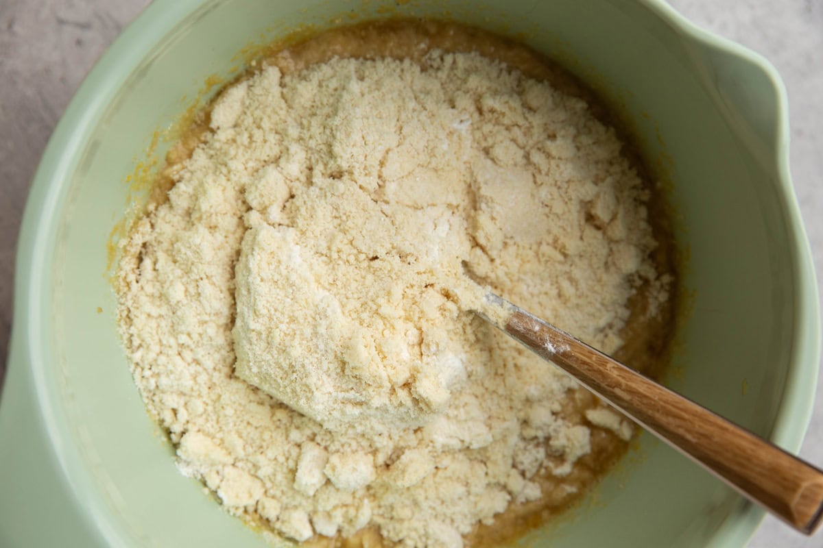 Mixing bowl with wet ingredients in the bottom and dry ingredients on top, ready to be mixed in.