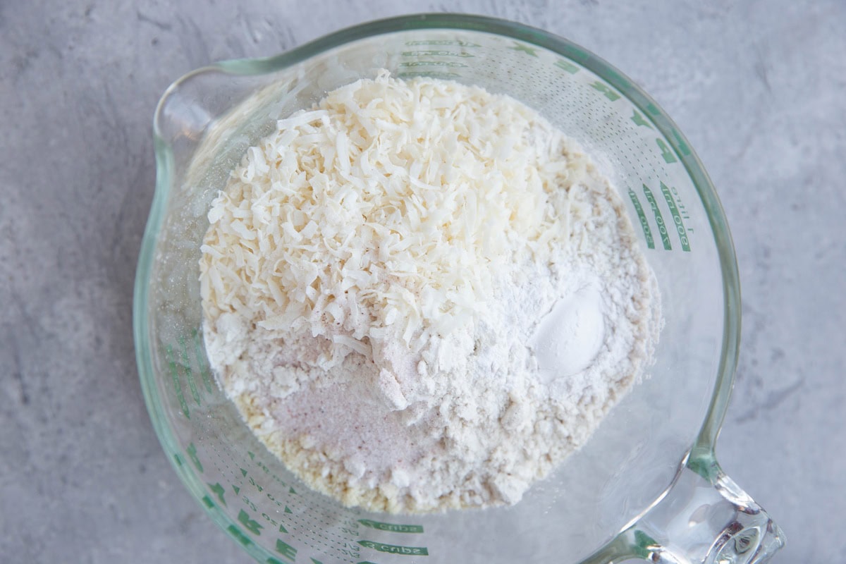 large measuring cup full of dry ingredients for carrot cake.