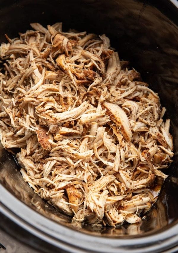slow cooker full of shredded chicken, ready to use.