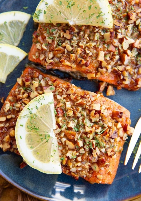 Two salmon filets on a plate, ready to eat.