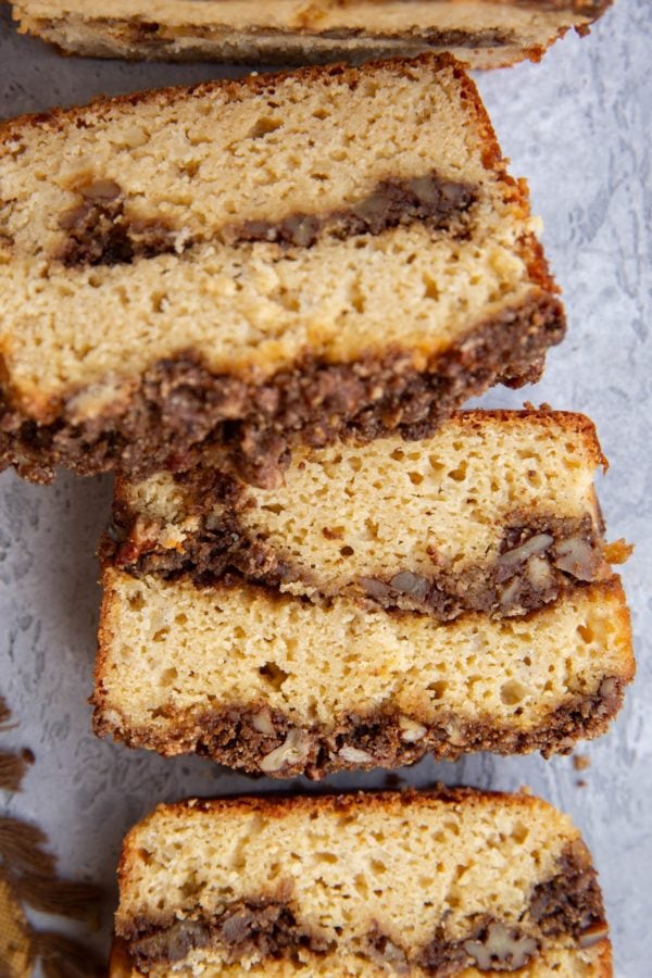 Loaf of cinnamon roll bread cut into individual slices, ready to eat.
