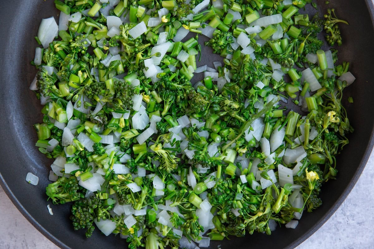 skillet full of sauteed broccoli and onions.