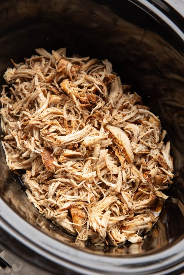 slow cooker full of shredded chicken, ready to use.
